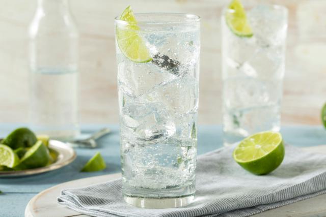 tall glasses filled with ice and lime