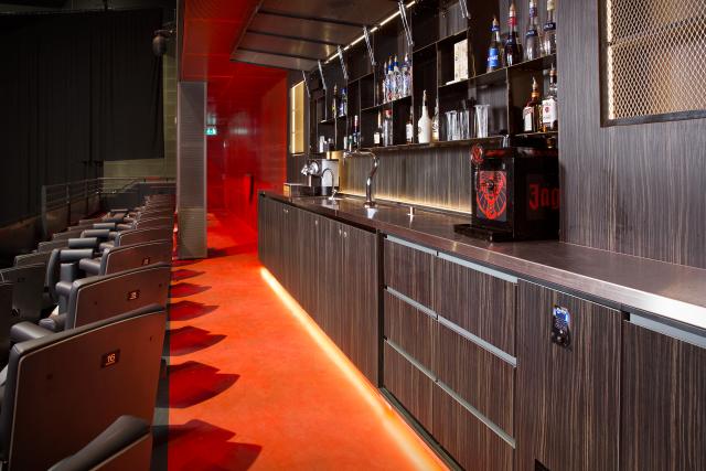 bar in Amsterdam with chairs, bar area, tables and chairs and refrigeration