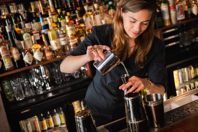 Tess Posthumus pours a cocktail