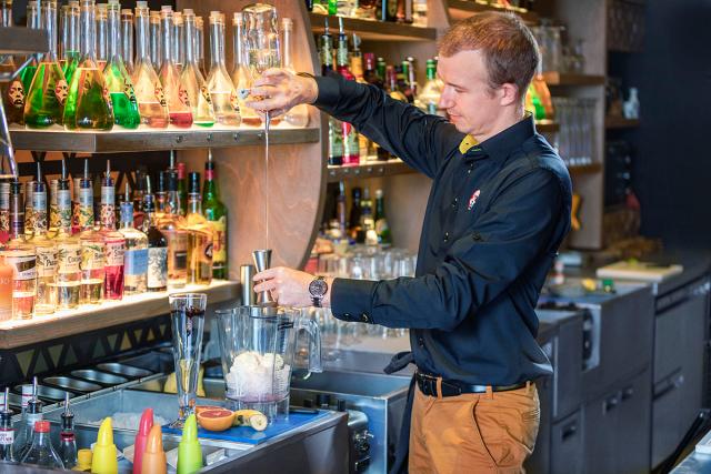 a bartender prepares a cocktail