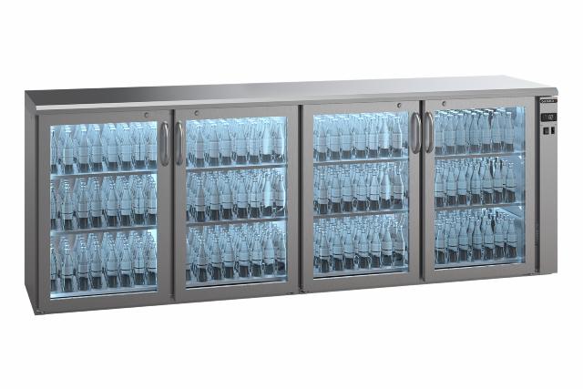 An E3 bottle cooler with 4 glass doors is viewed from an angle. The counter is filled with beautifully illuminated bottles.